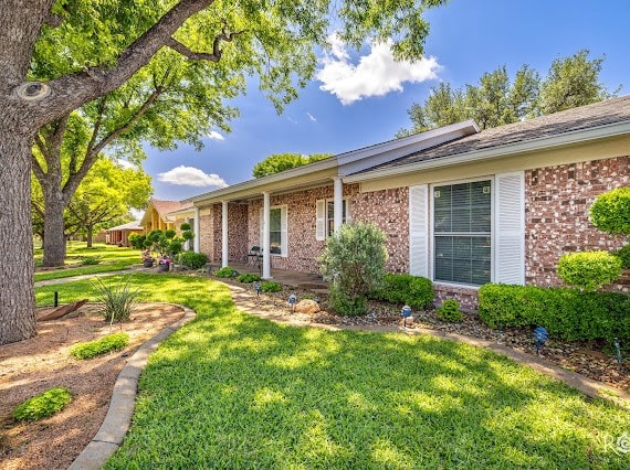 3309 Cedarhill Dr, San Angelo, TX 76904 - view of property exterior with brick siding and a yard