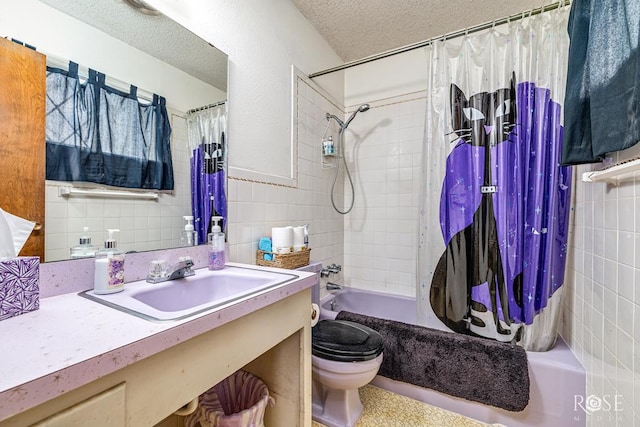 1714 Shady Point Circle Dr, San Angelo, TX 76904 - full bath featuring tile walls, toilet, vanity, shower / bath combo with shower curtain, and a textured ceiling