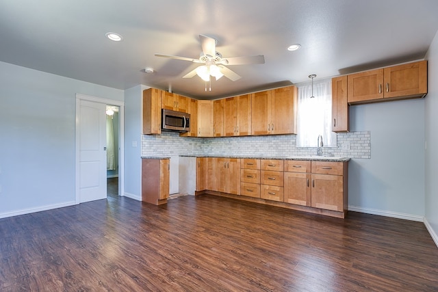 kitchen featuring stainless steel microwave, a ceiling fan, backsplash, baseboards, and recessed lighting