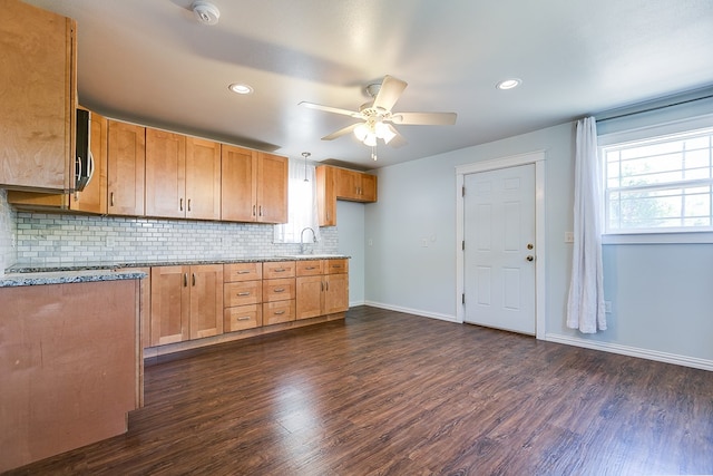 kitchen with dark wood-type flooring, a ceiling fan, decorative backsplash, a sink, and recessed lighting