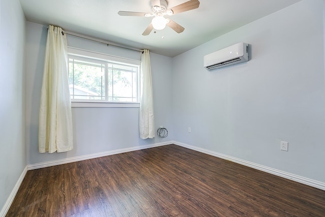 spare room featuring a wall mounted AC, wood finished floors, baseboards, and a ceiling fan