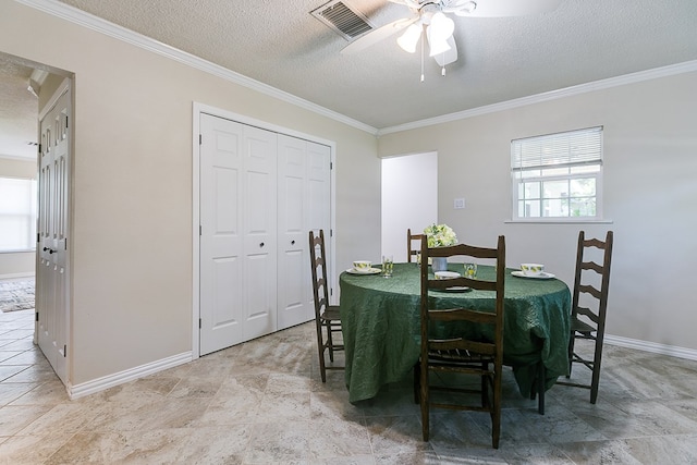 dining area with a textured ceiling, ornamental molding, a ceiling fan, and baseboards