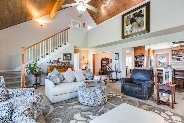 living room featuring wood ceiling, ceiling fan, beam ceiling, and high vaulted ceiling