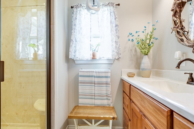 bathroom featuring vanity and a shower with door