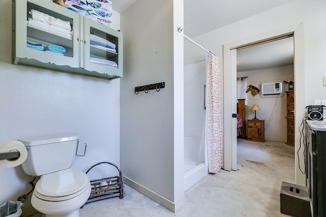 bathroom with an AC wall unit, concrete floors, toilet, and a shower with shower curtain