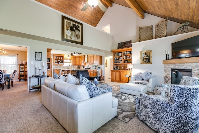 carpeted living room featuring beam ceiling, wood ceiling, high vaulted ceiling, a fireplace, and ceiling fan with notable chandelier