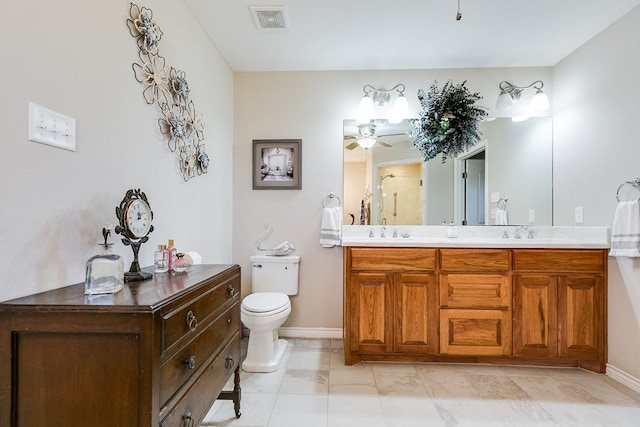 bathroom featuring vanity, ceiling fan, and toilet