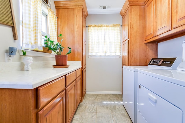 washroom with cabinets and separate washer and dryer