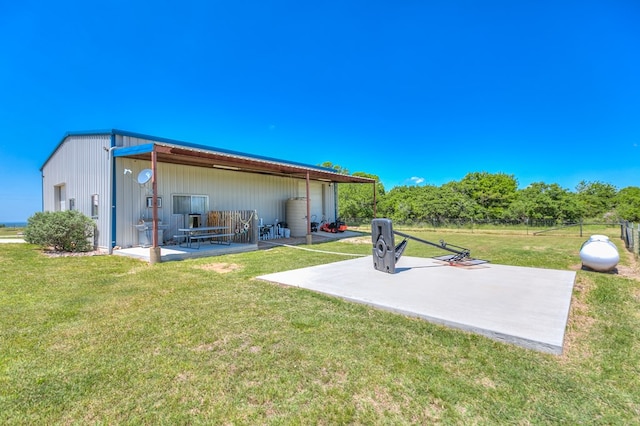 rear view of property featuring a patio and a yard