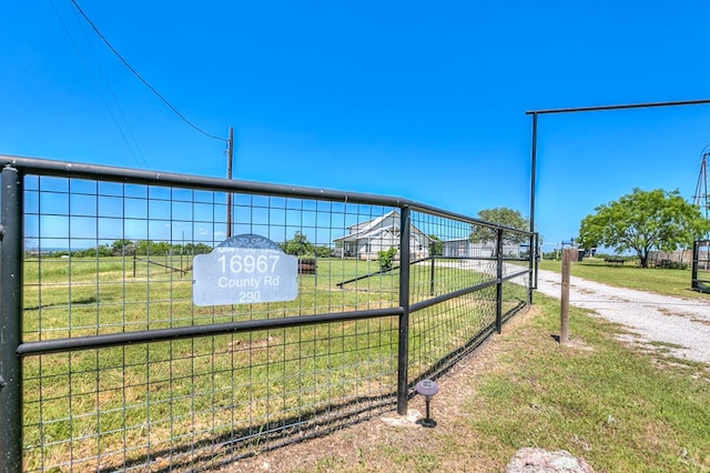 view of gate with a yard