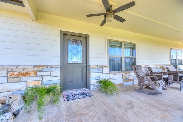 view of exterior entry with ceiling fan