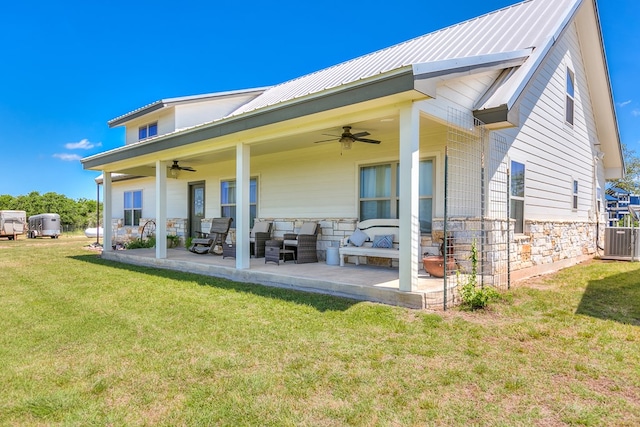 rear view of property with a yard, central air condition unit, ceiling fan, and a patio area