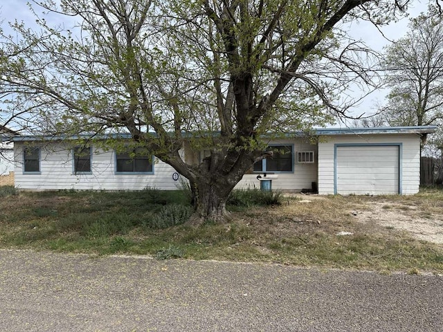 ranch-style home with driveway and a garage