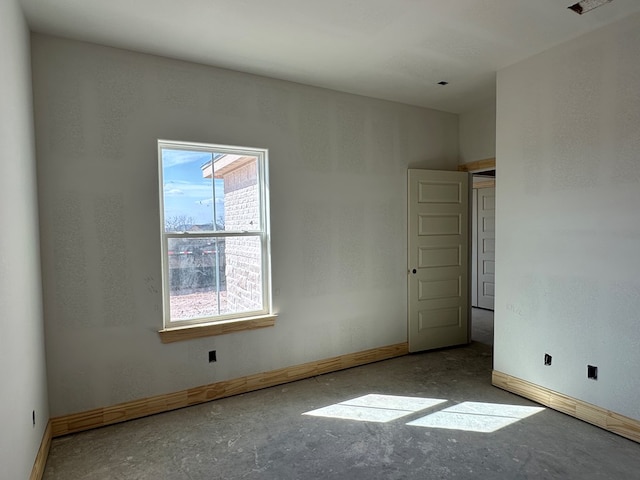 spare room featuring baseboards