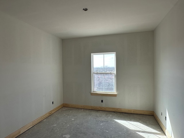 spare room featuring baseboards