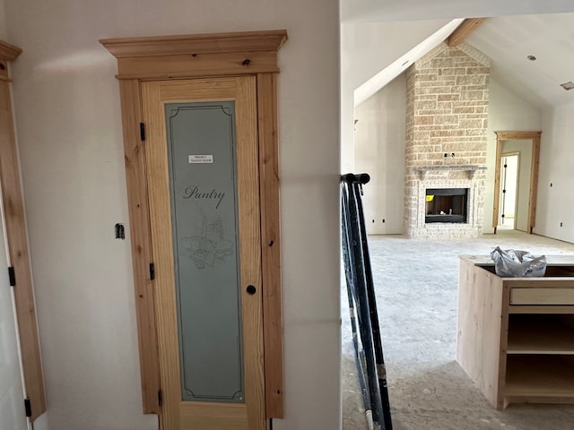 hall featuring vaulted ceiling with beams