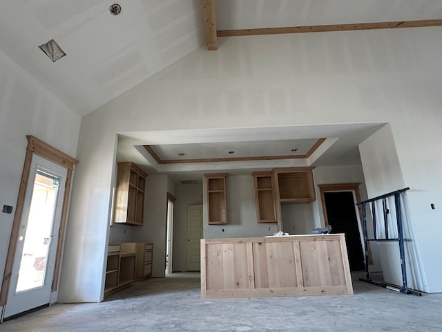 kitchen with a center island, high vaulted ceiling, a raised ceiling, and open shelves