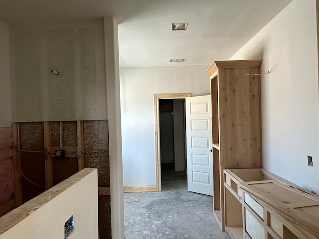 interior space featuring walk in shower, visible vents, and concrete floors