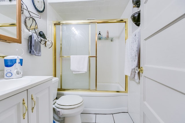 full bathroom with tile patterned floors, vanity, toilet, and combined bath / shower with glass door