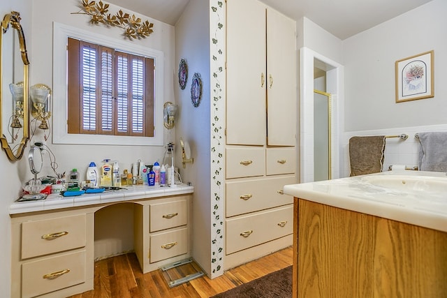 bathroom with hardwood / wood-style flooring and vanity