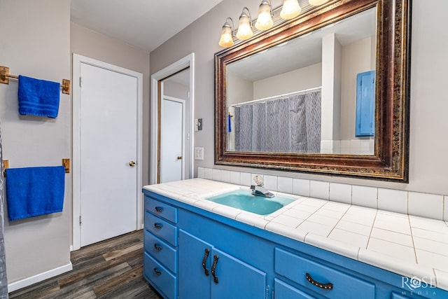 1902 College Hills Blvd, San Angelo, TX 76904 - full bathroom featuring wood finished floors, vanity, and baseboards