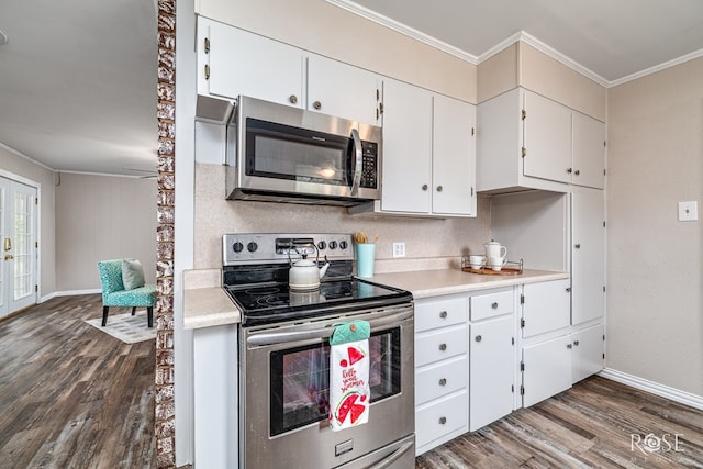 1902 College Hills Blvd, San Angelo, TX 76904 - kitchen with stainless steel appliances, ornamental molding, dark wood-type flooring, light countertops, and white cabinetry