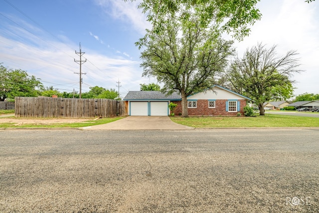 1902 College Hills Blvd, San Angelo, TX 76904 - ranch-style house with a garage, driveway, and brick siding