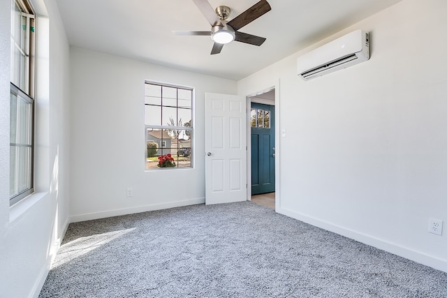 carpeted spare room featuring ceiling fan and a wall unit AC