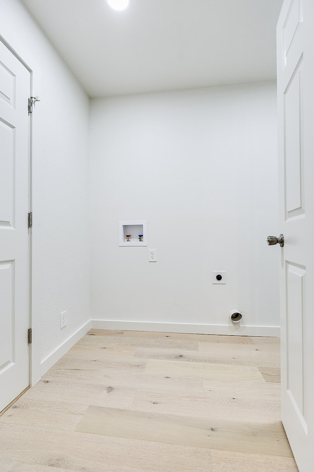 clothes washing area with washer hookup, hookup for an electric dryer, and light hardwood / wood-style flooring