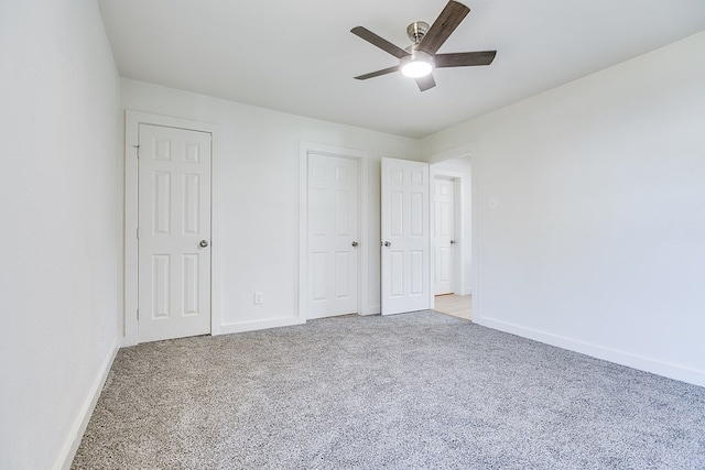 unfurnished bedroom with ceiling fan and light carpet