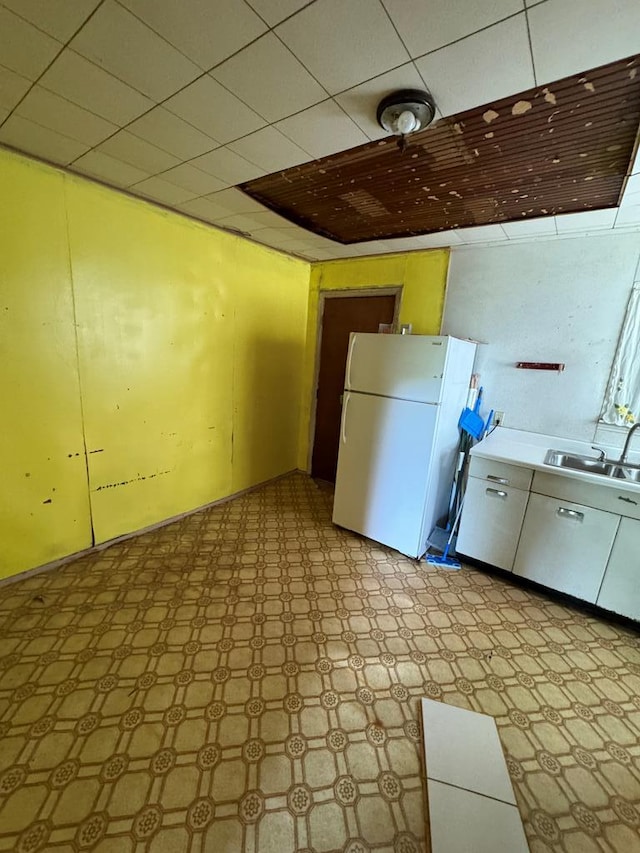 kitchen featuring white fridge and sink