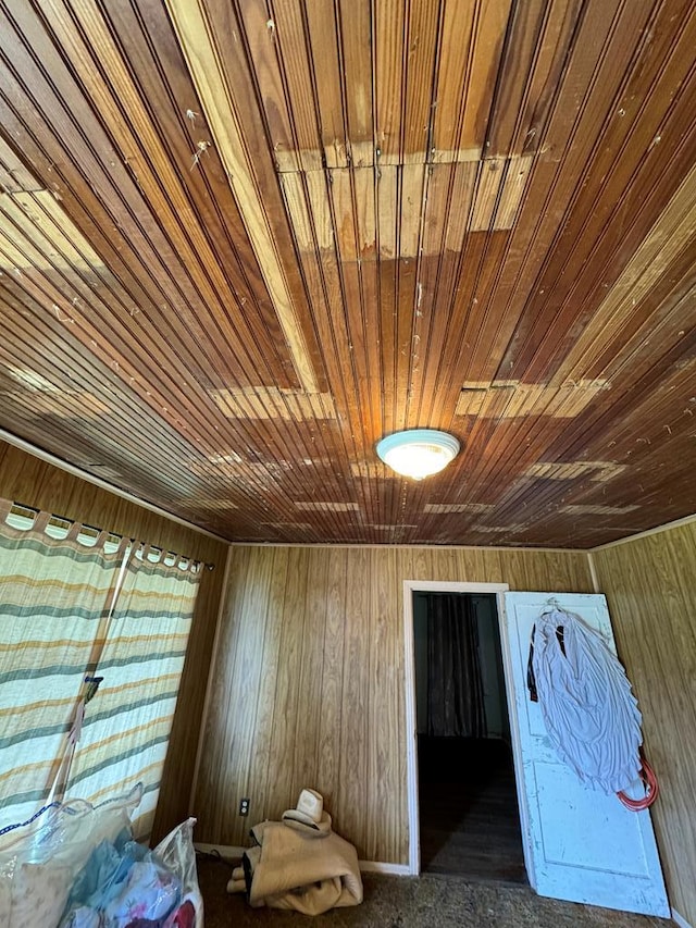 interior space featuring wood ceiling and wood walls