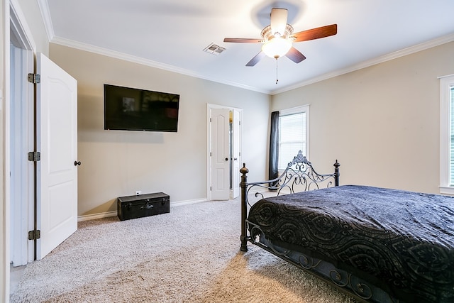 bedroom with ceiling fan, ornamental molding, and light carpet