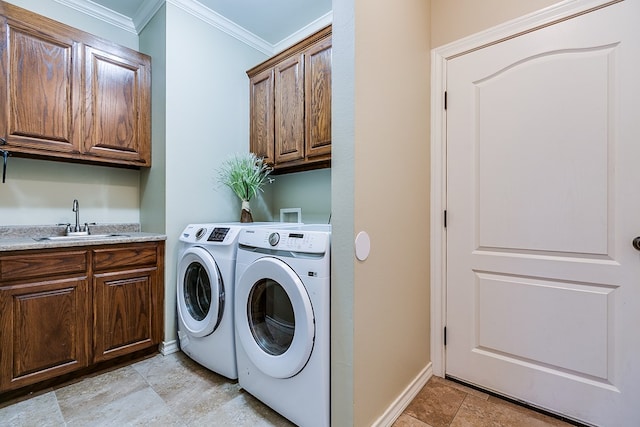 laundry room with cabinets, sink, ornamental molding, and washing machine and clothes dryer