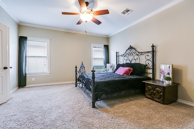 carpeted bedroom featuring multiple windows, ornamental molding, and ceiling fan