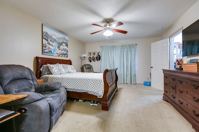 205 Kennedy St, San Angelo, TX 76905 - bedroom featuring light carpet, a ceiling fan, and a textured ceiling