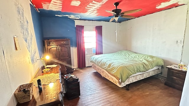 bedroom featuring dark hardwood / wood-style flooring and ceiling fan