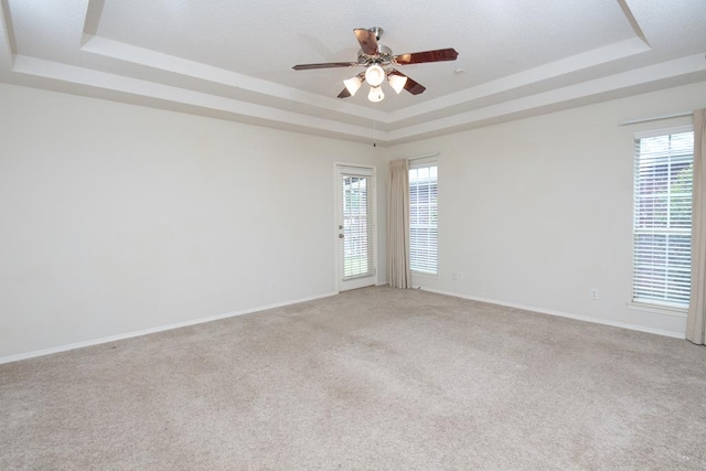 4206 Pinon Ridge Dr, San Angelo, TX 76904 - carpeted empty room featuring a raised ceiling, a ceiling fan, and baseboards