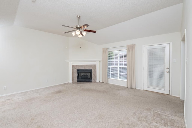 4206 Pinon Ridge Dr, San Angelo, TX 76904 - unfurnished living room with vaulted ceiling, ceiling fan, carpet flooring, a fireplace, and baseboards