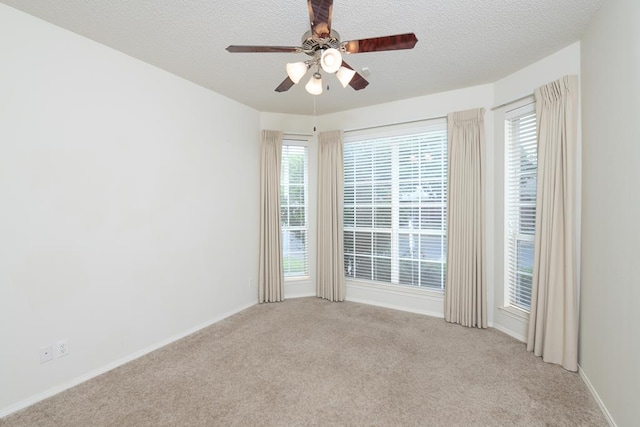 4206 Pinon Ridge Dr, San Angelo, TX 76904 - unfurnished room with light colored carpet, a ceiling fan, a textured ceiling, and baseboards