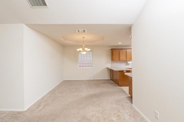 4206 Pinon Ridge Dr, San Angelo, TX 76904 - unfurnished dining area with a chandelier, light colored carpet, baseboards, and a tray ceiling