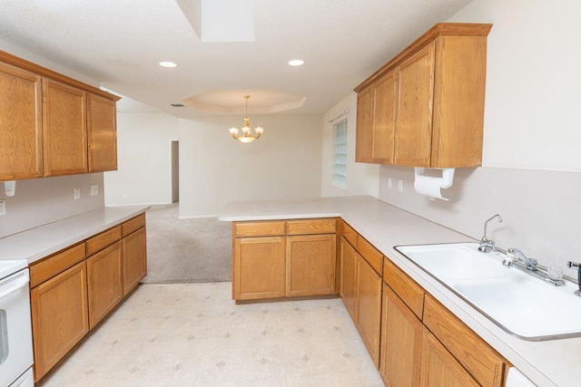 4206 Pinon Ridge Dr, San Angelo, TX 76904 - kitchen with a sink, a chandelier, a peninsula, light countertops, and recessed lighting