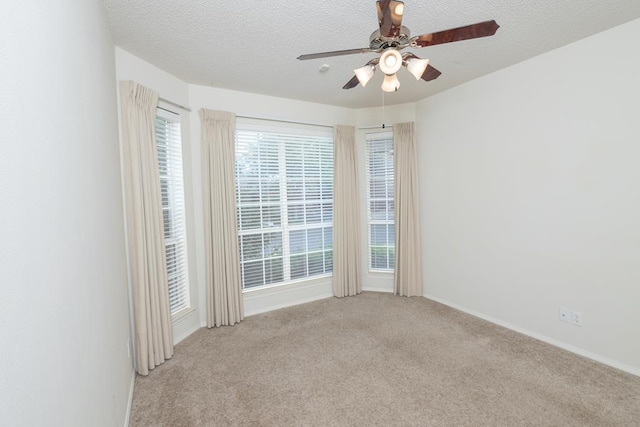 4206 Pinon Ridge Dr, San Angelo, TX 76904 - empty room with ceiling fan, light colored carpet, baseboards, and a textured ceiling