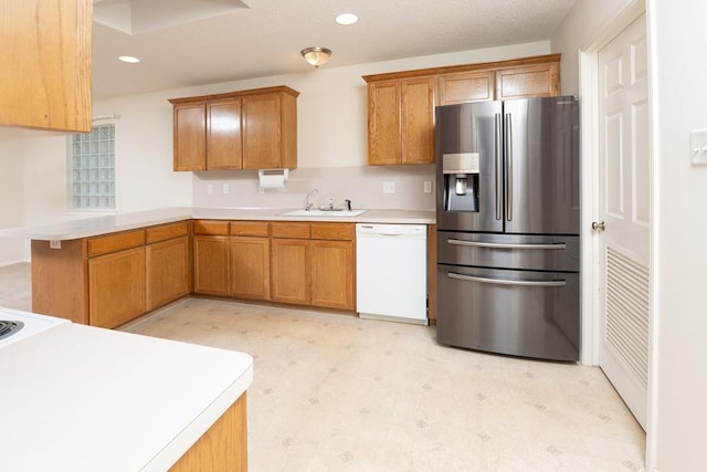 4206 Pinon Ridge Dr, San Angelo, TX 76904 - kitchen featuring stainless steel fridge, dishwasher, a sink, light flooring, and light countertops