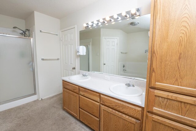 4206 Pinon Ridge Dr, San Angelo, TX 76904 - full bathroom featuring a stall shower, a bath, double vanity, and carpet