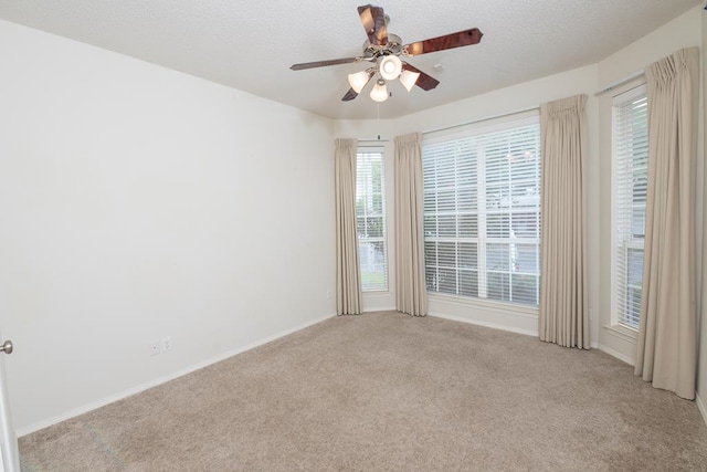 4206 Pinon Ridge Dr, San Angelo, TX 76904 - empty room featuring light colored carpet, ceiling fan, baseboards, and a textured ceiling