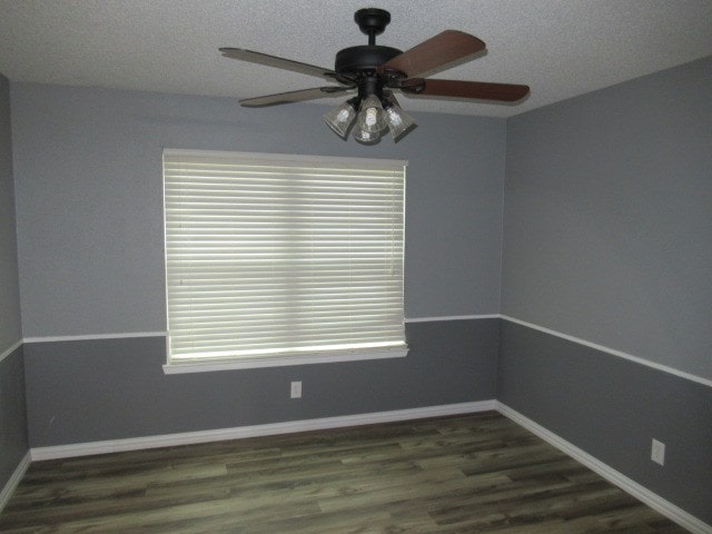 3606 Old Post Rd, San Angelo, TX 76904 - empty room featuring a ceiling fan, plenty of natural light, dark wood-style flooring, and a textured ceiling