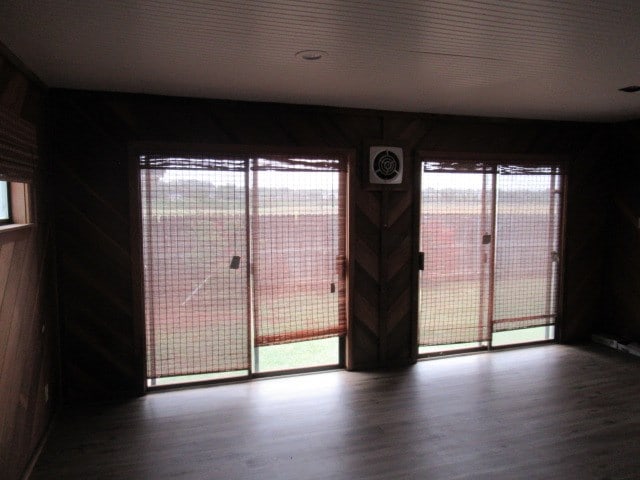 3606 Old Post Rd, San Angelo, TX 76904 - spare room featuring wood finished floors and wooden walls