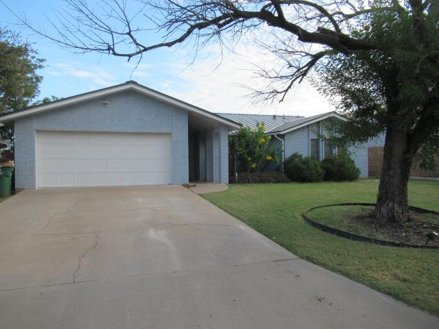 3606 Old Post Rd, San Angelo, TX 76904 - view of front of property with brick siding, driveway, a front lawn, and a garage