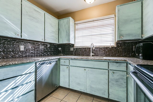 3101 Grove Dr, San Angelo, TX 76903 - kitchen with stainless steel dishwasher, tasteful backsplash, light tile patterned floors, and stove